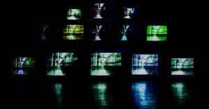 Photo by Murai .hr on Unsplash. Image of TV screens in dark room